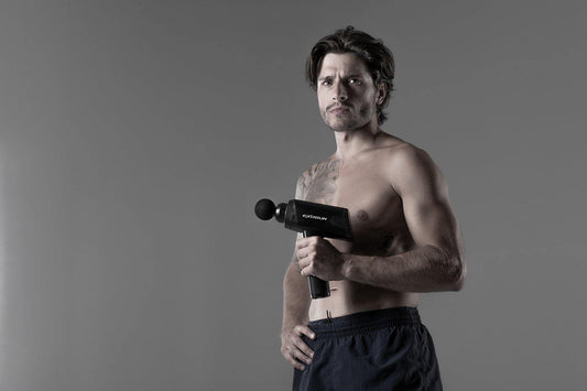 Beautiful-man-gym-percussion-therapy-gun